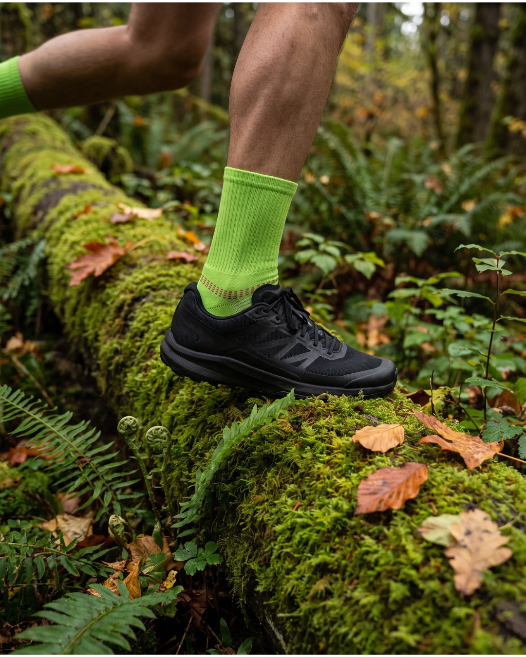 Trail shoe and Volt Green SEDZ running sock on a mossy woodland trail